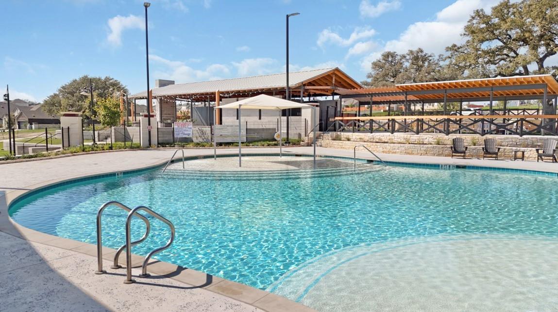 Community pool with a patio