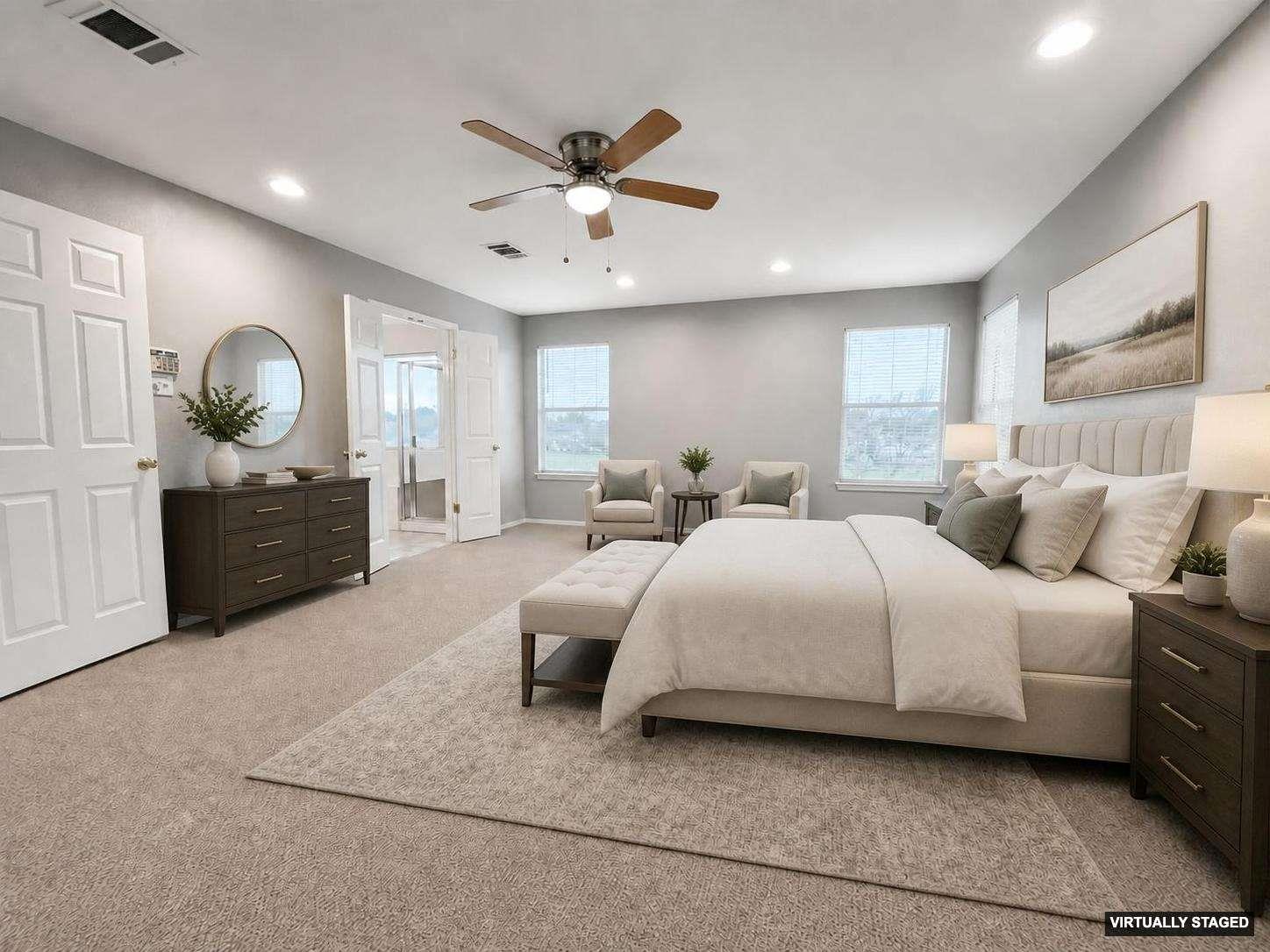 Spacious room featuring neutral carpeting, a ceiling fan with integrated lighting, recessed lighting, and multiple windows
