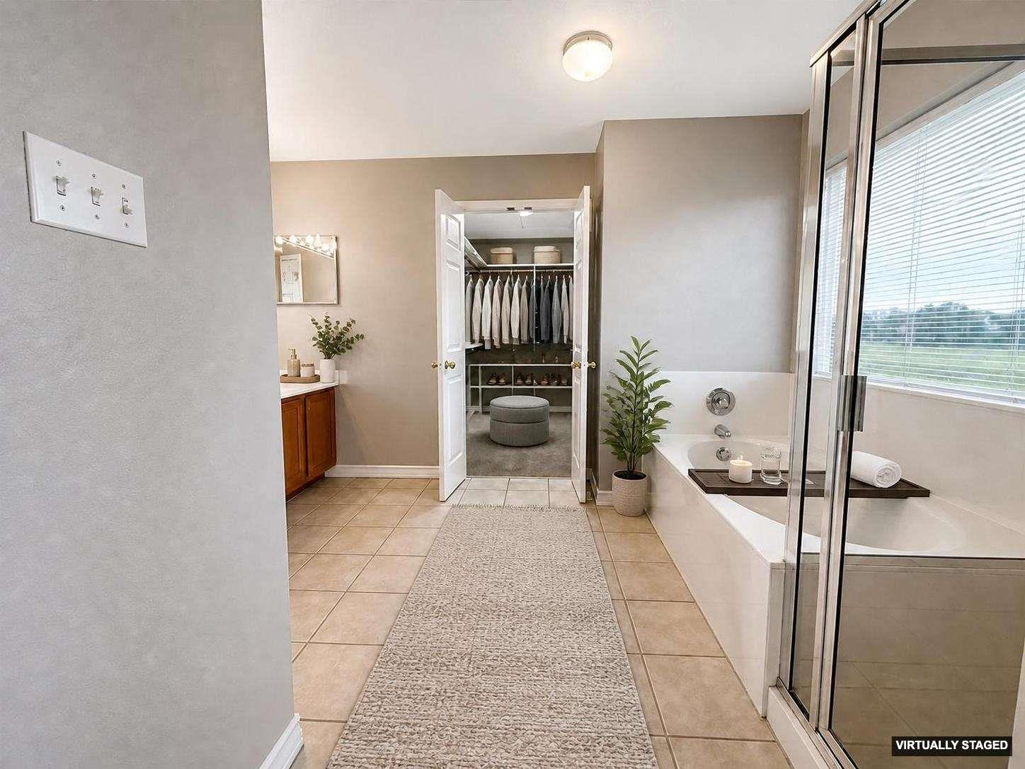 Bathroom featuring a built-in soaking tub and an adjacent glass-enclosed shower
