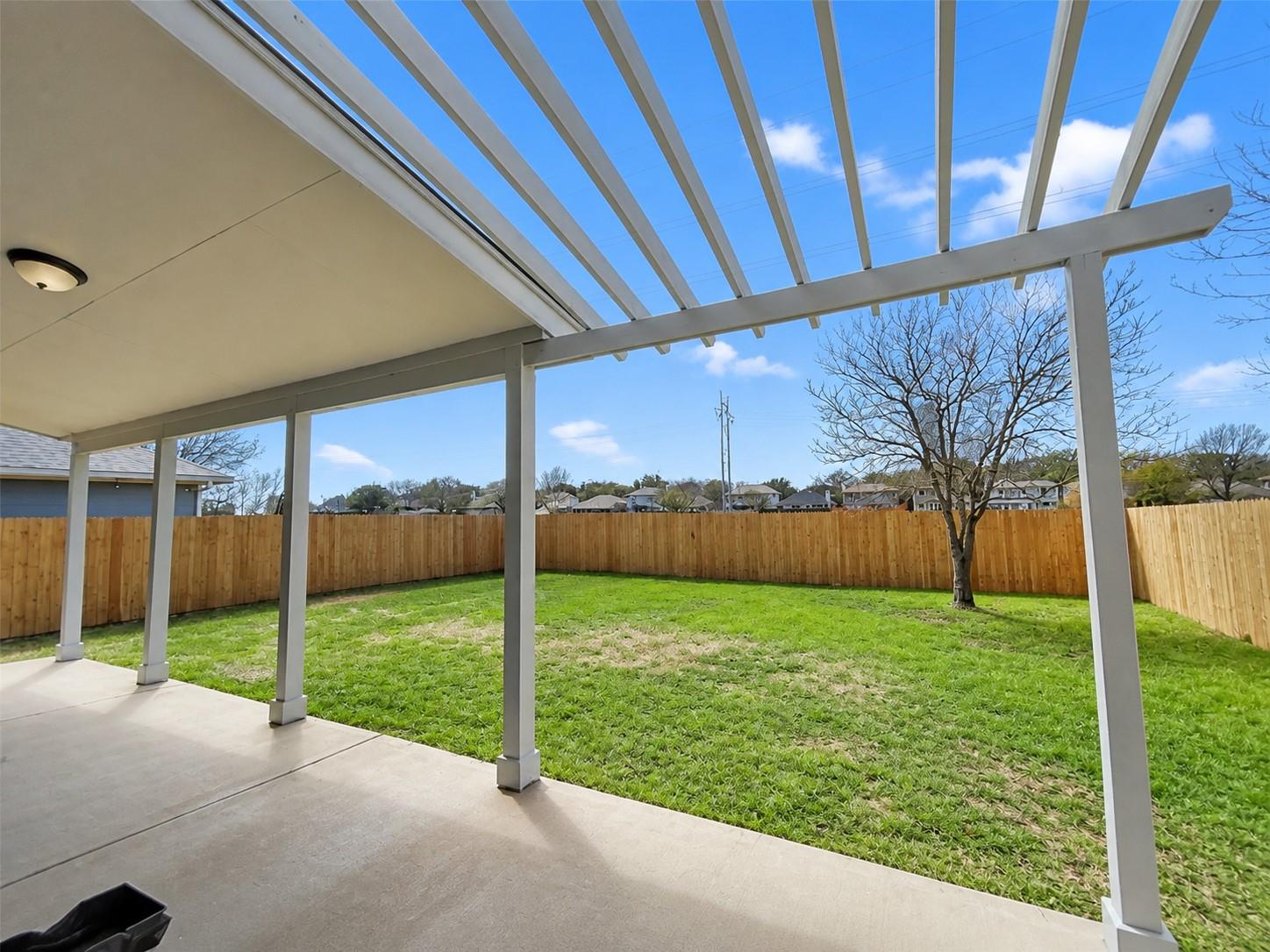 Covered patio featuring a concrete slab and a pergola extension