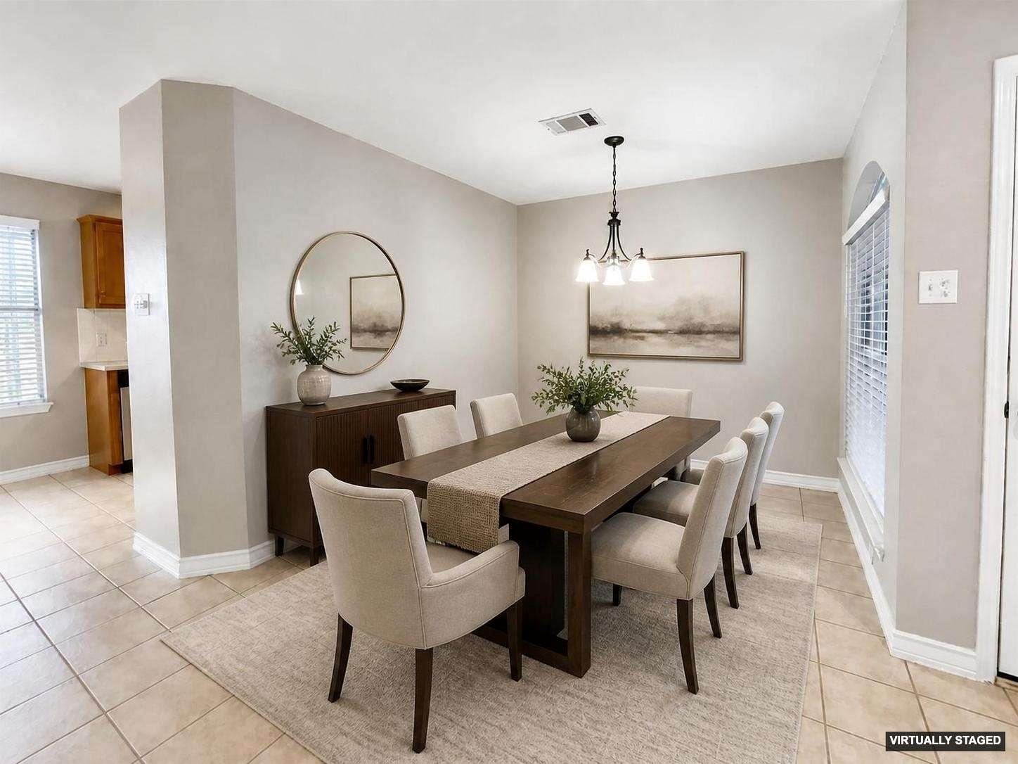Spacious dining area featuring neutral wall tones and tile flooring