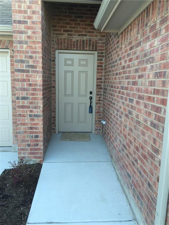 A classic brick exterior welcomes you home with a tidy concrete pathway leading to the entry.