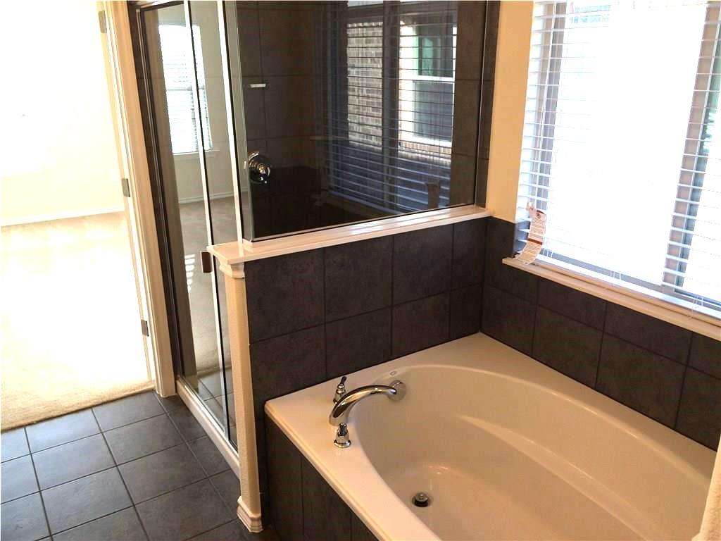 Indulge in a tranquil bathing experience with this spacious soaking tub.