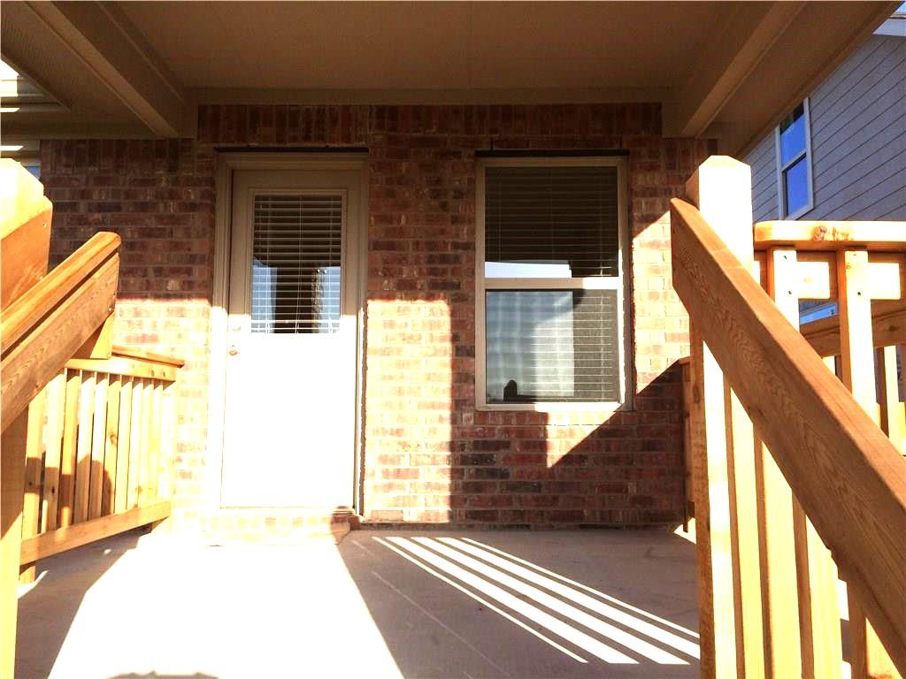 A welcoming rear porch offers direct access and a cheerful spot to enjoy the outdoors.