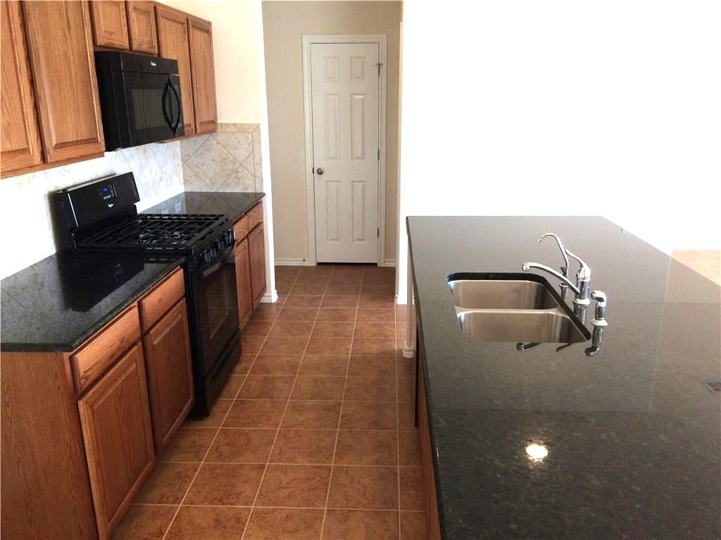 A well-appointed culinary space featuring ample counter surfaces and modern appliances.