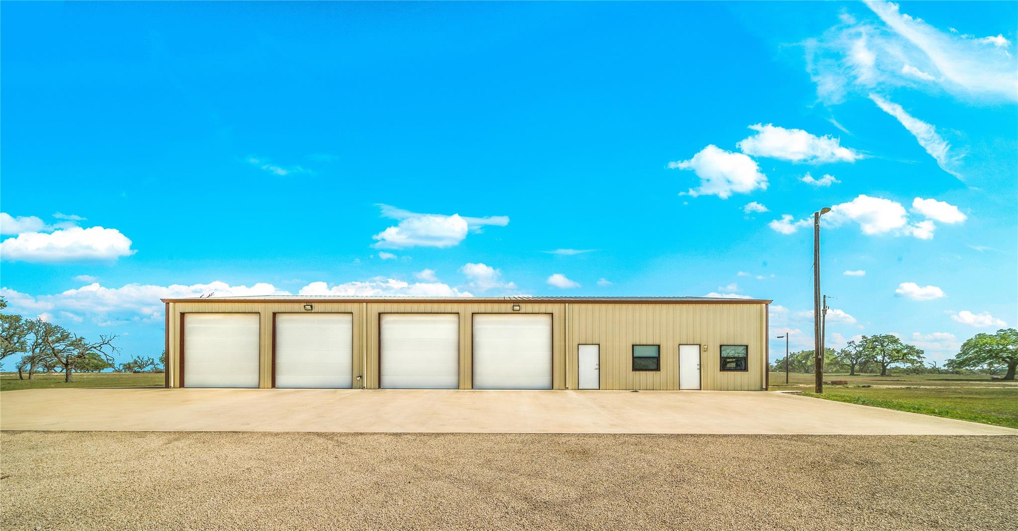 A utilitarian structure with multiple bay doors, perfectly suited for various commercial or storage needs.