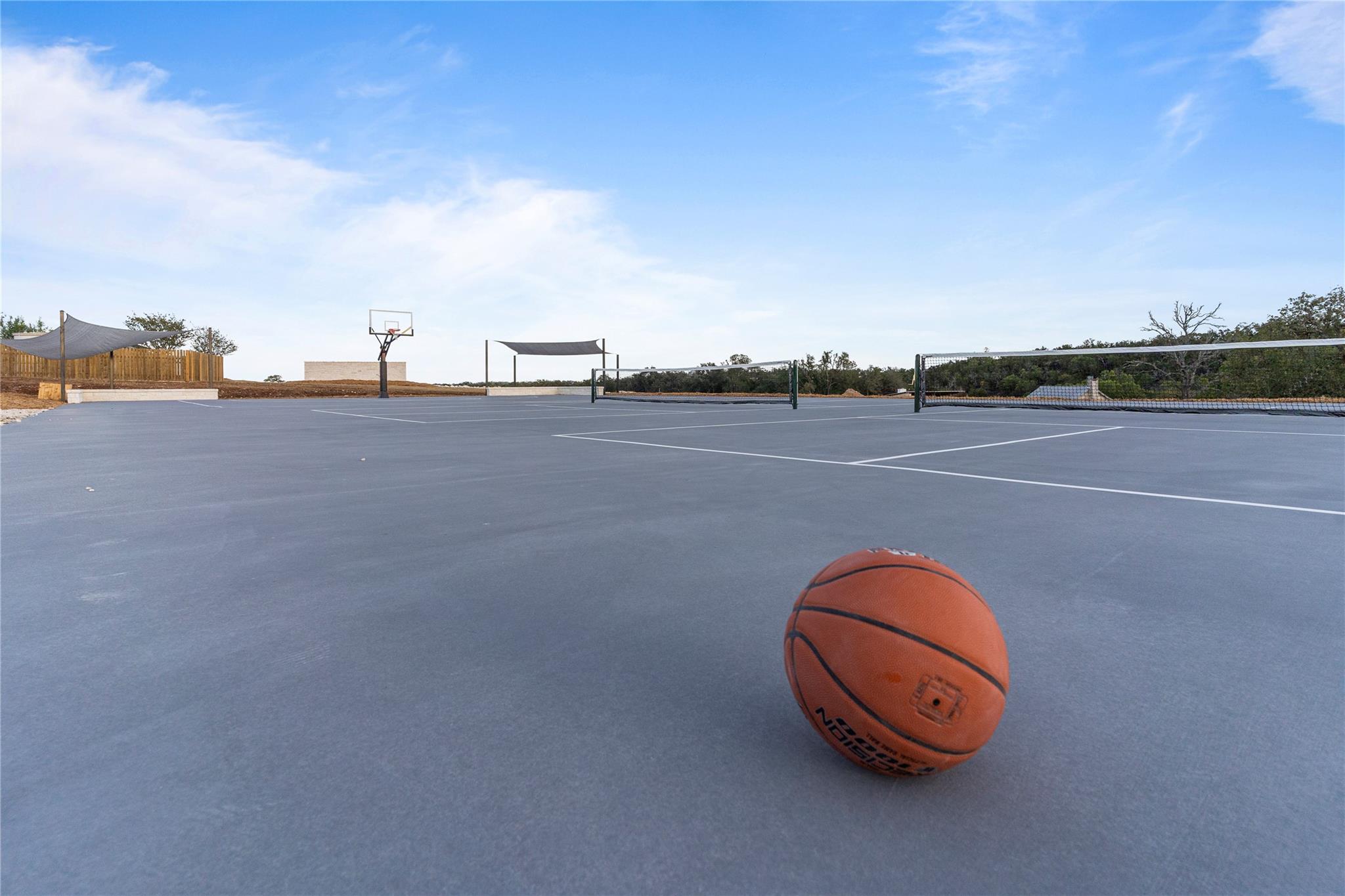 An outdoor court offers endless recreation with both tennis and basketball facilities available.