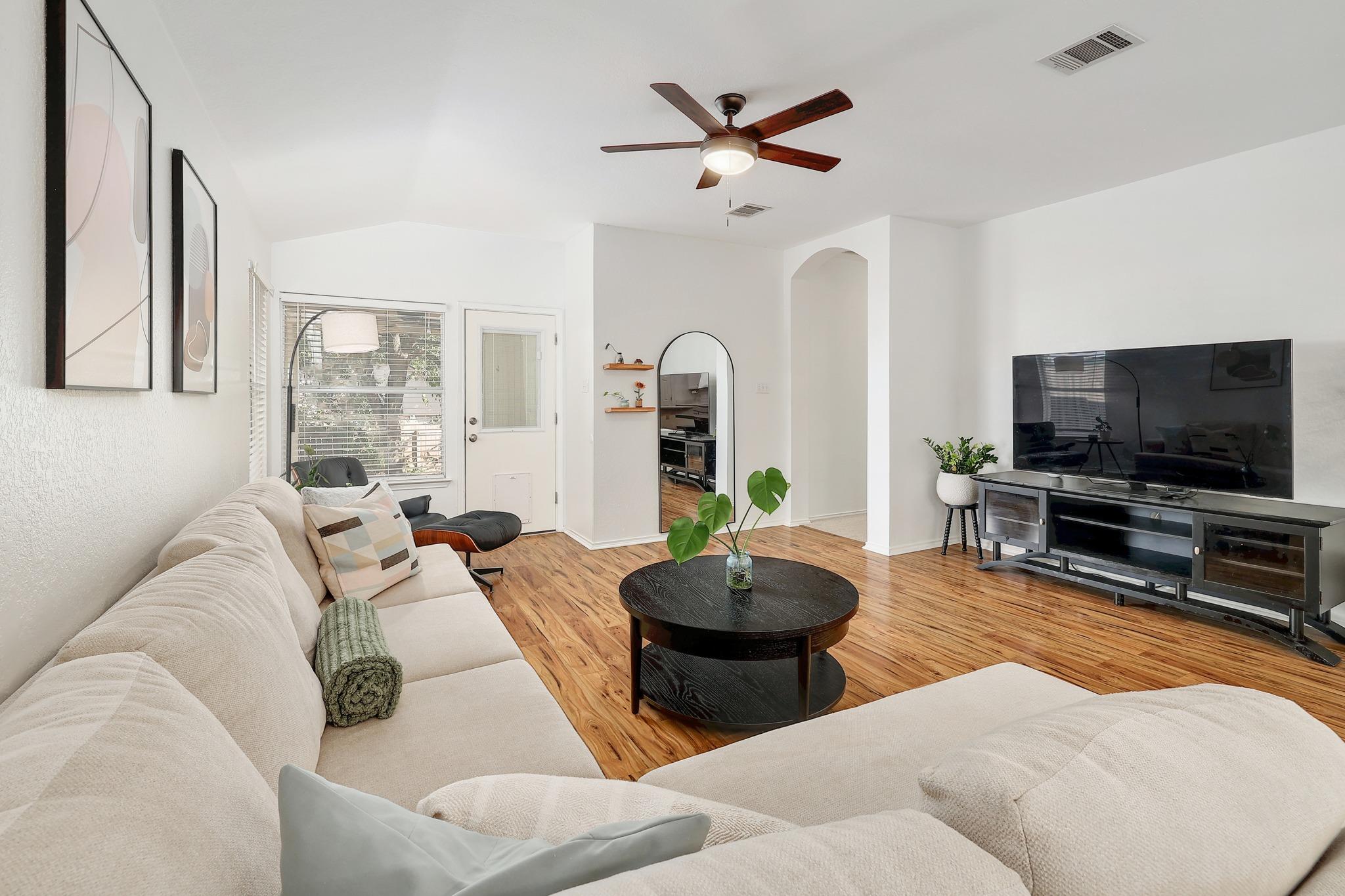 The flooring complements the vaulted ceiling and arched doorway of this inviting space.