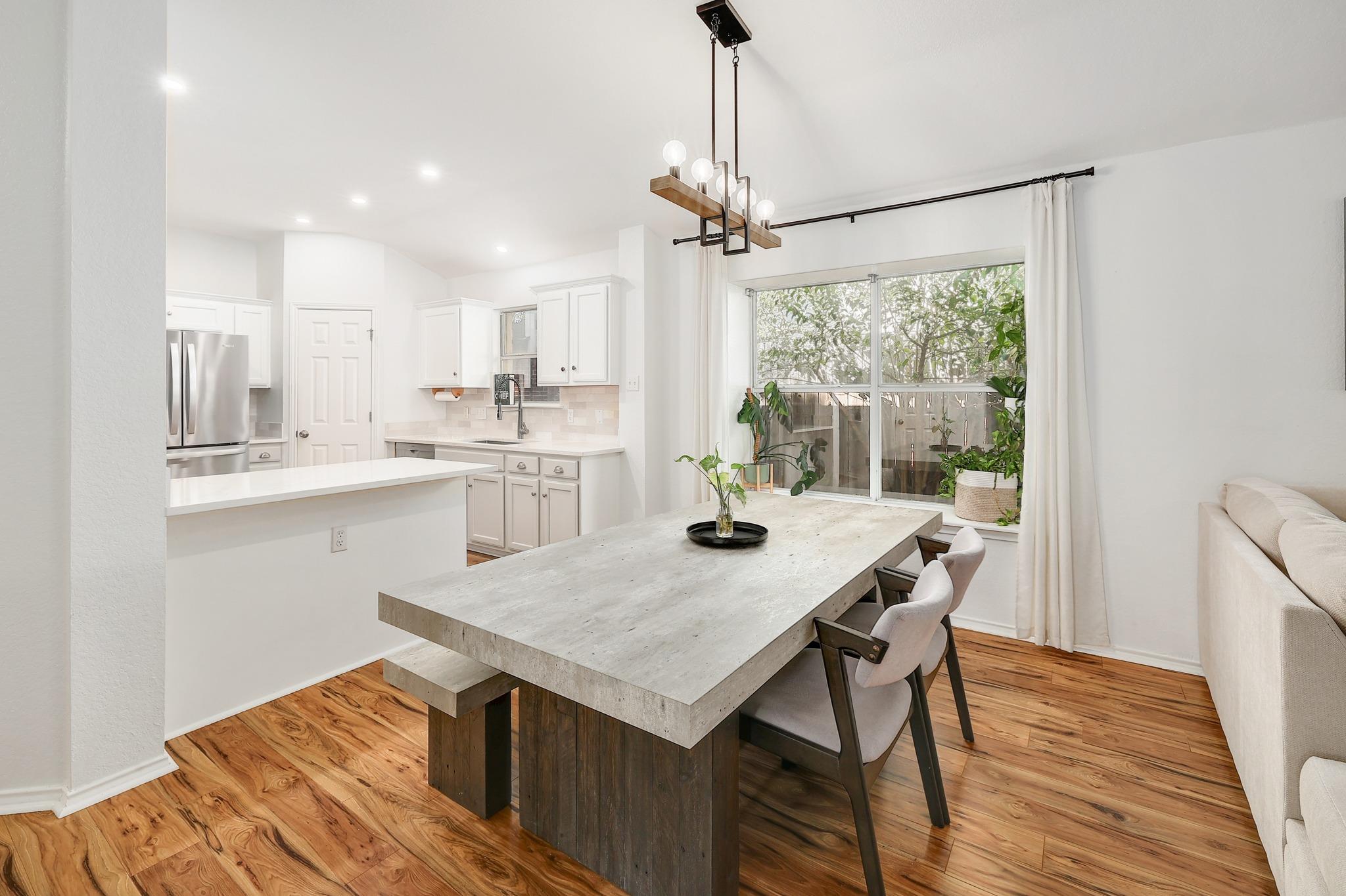 Dining space bordering an open-concept kitchen.