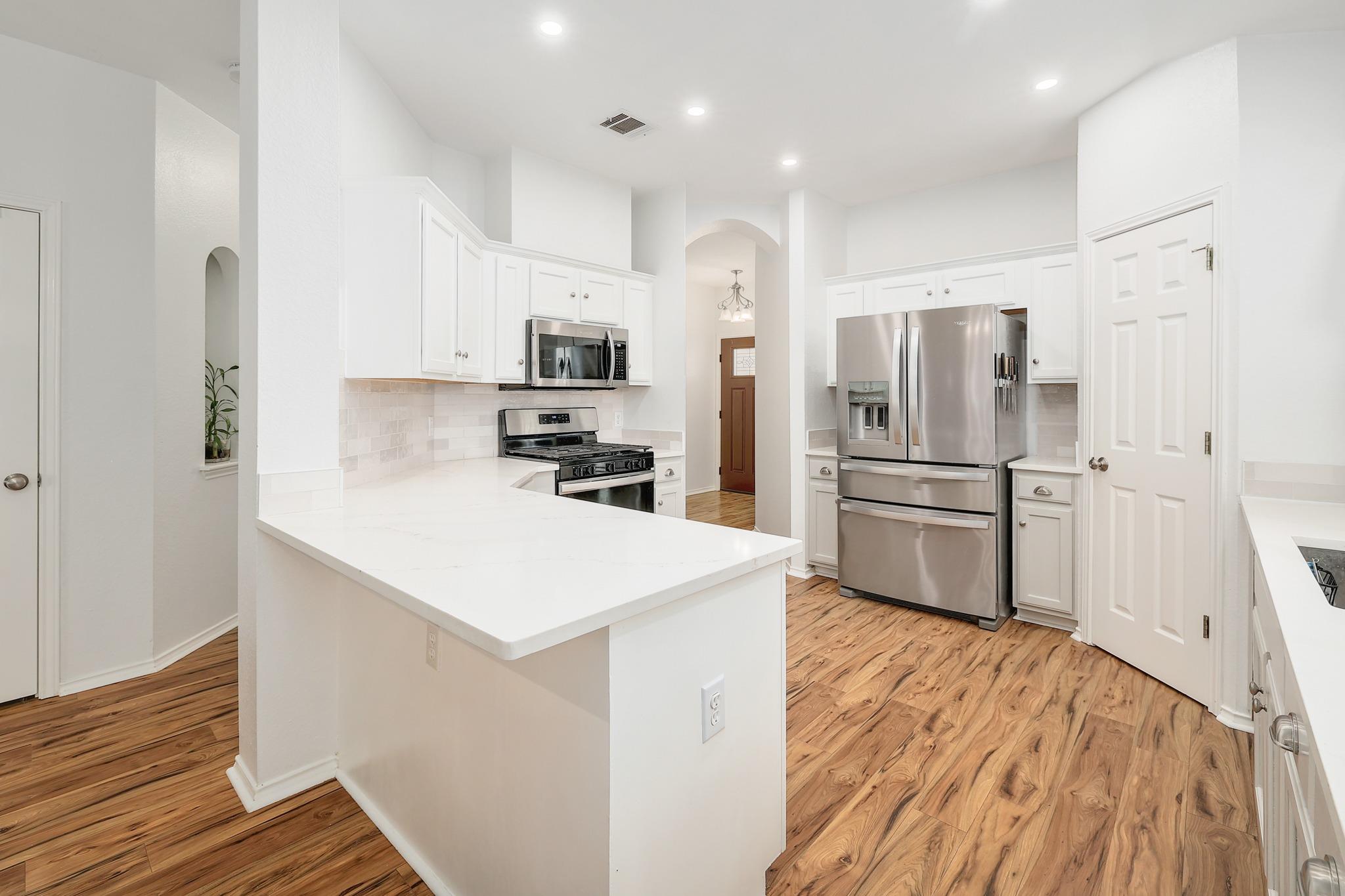 Countertops define this bright culinary space.