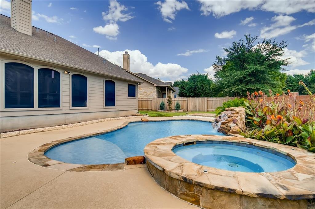The pool decking and spa exterior are flagstone, and the windows have solar screens to protect the interior from the heat.