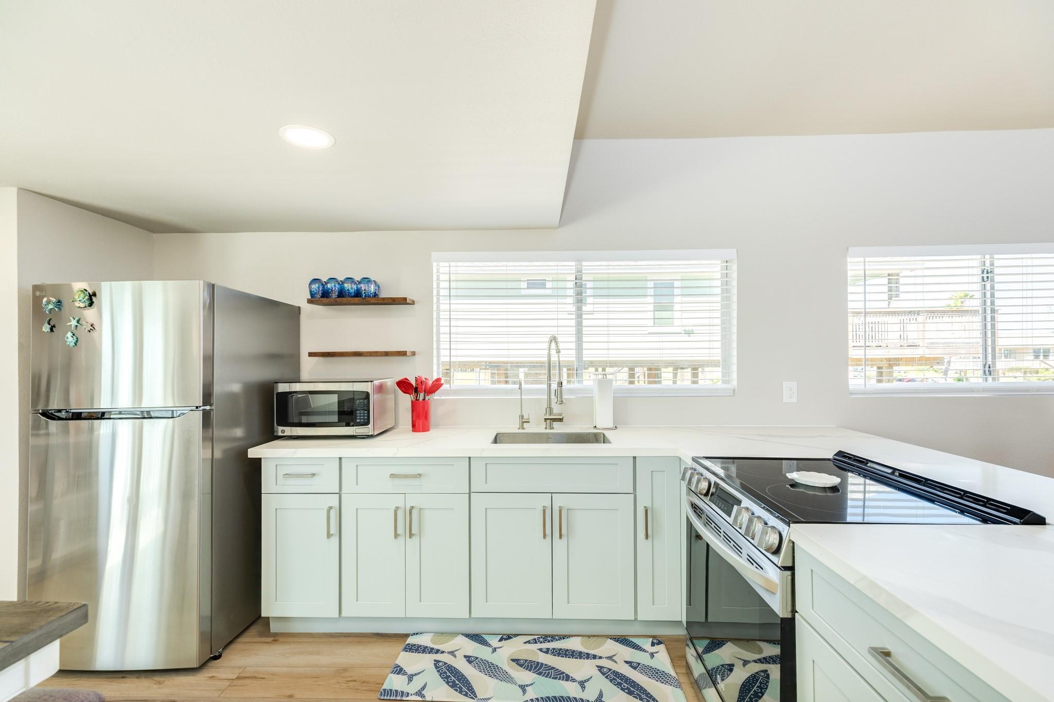 Kitchen – Functional layout with stainless steel appliances, ample counter space, and plenty of cabinetry for storage.