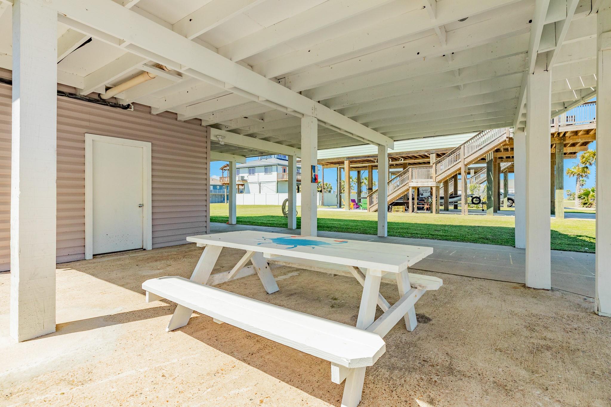 Outdoor Entertaining Space –  picnic table and open concrete area offer a casual setting for outdoor dining or entertaining.