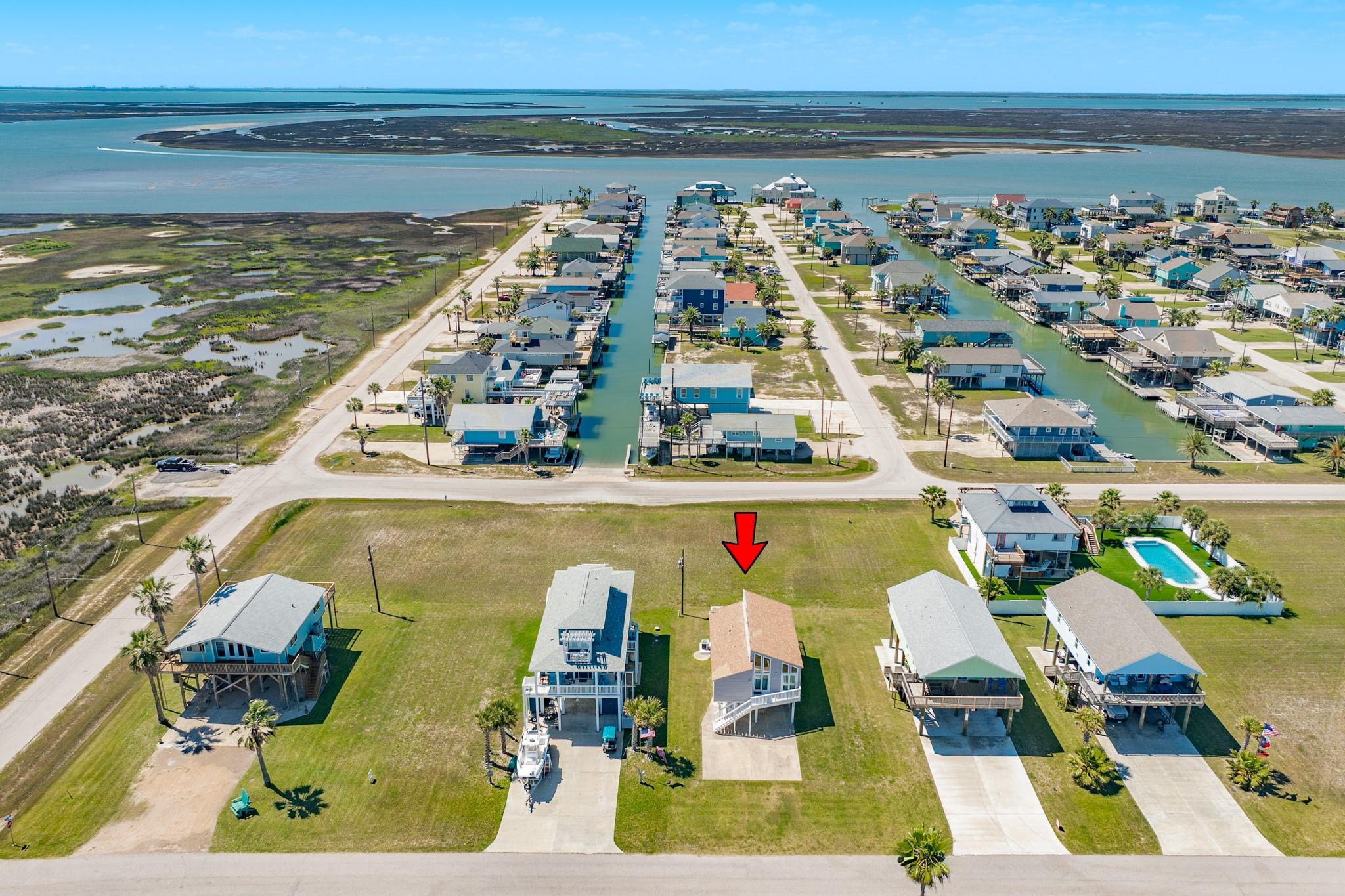 Aerial Neighborhood View – Located near canal-lined streets with easy access to surrounding waterways, showcasing a relaxed coastal lifestyle and scenic surroundings.