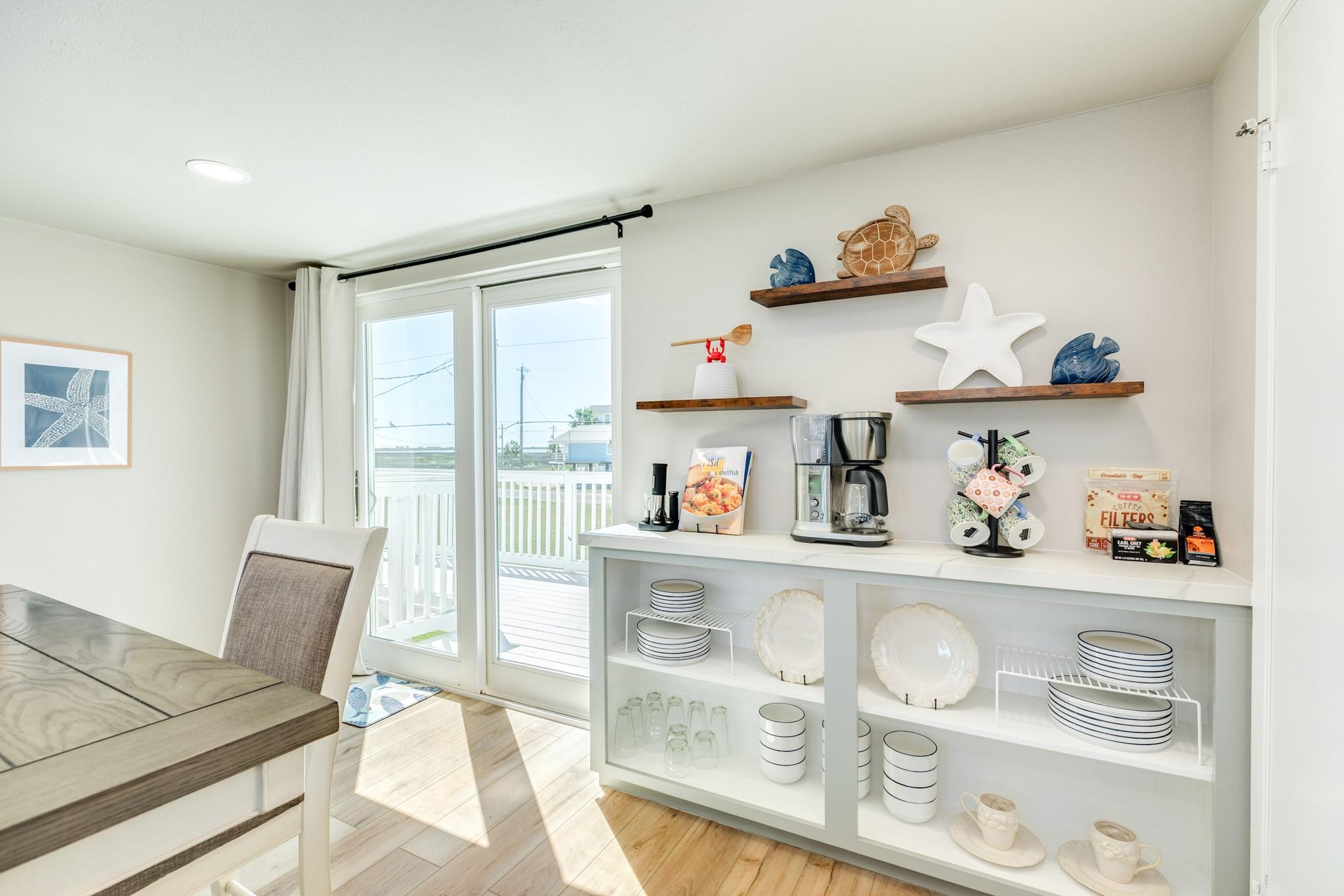 Coffee Bar / Serving Station – Built-in shelving and counter space provide a convenient area for coffee service or additional storage.