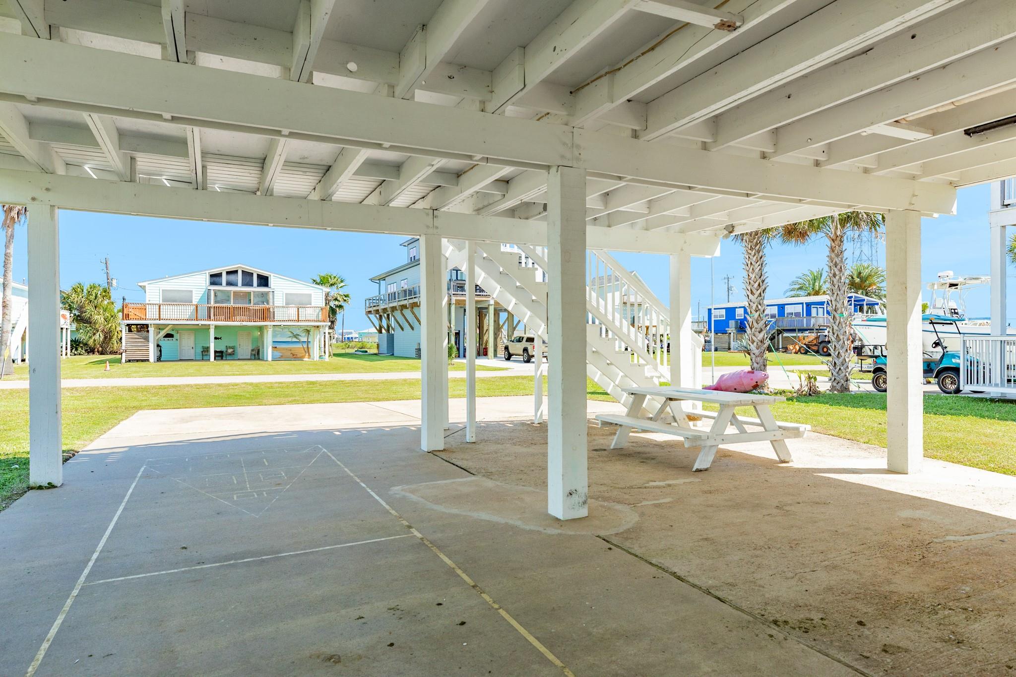 Covered Outdoor Area – Expansive shaded space beneath the home creates a versatile area for gatherings, games, or relaxing out of the sun.