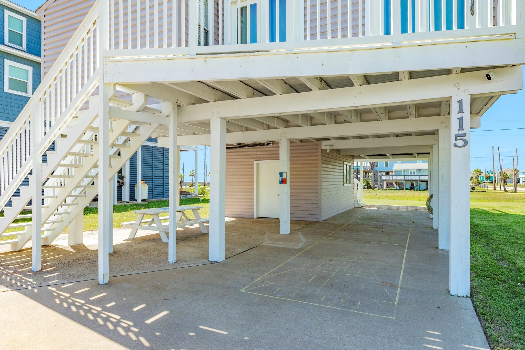 Covered Parking Area – Spacious ground-level parking with room for multiple vehicles, boats, or recreational gear, all protected under the home.