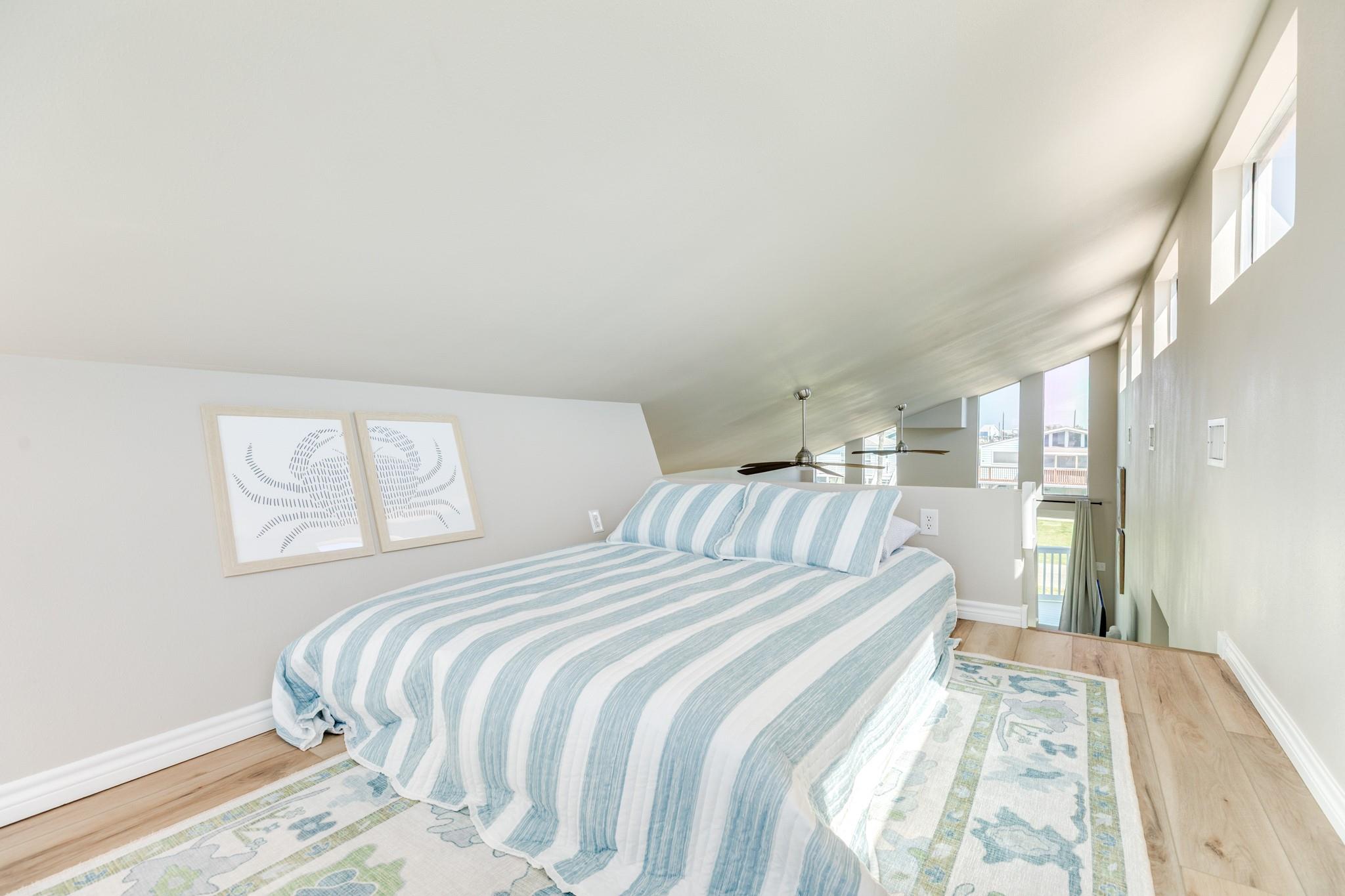 Loft Bedroom – Elevated vantage point overlooking the main living space, ideal for additional sleeping or a flexible bonus area.
