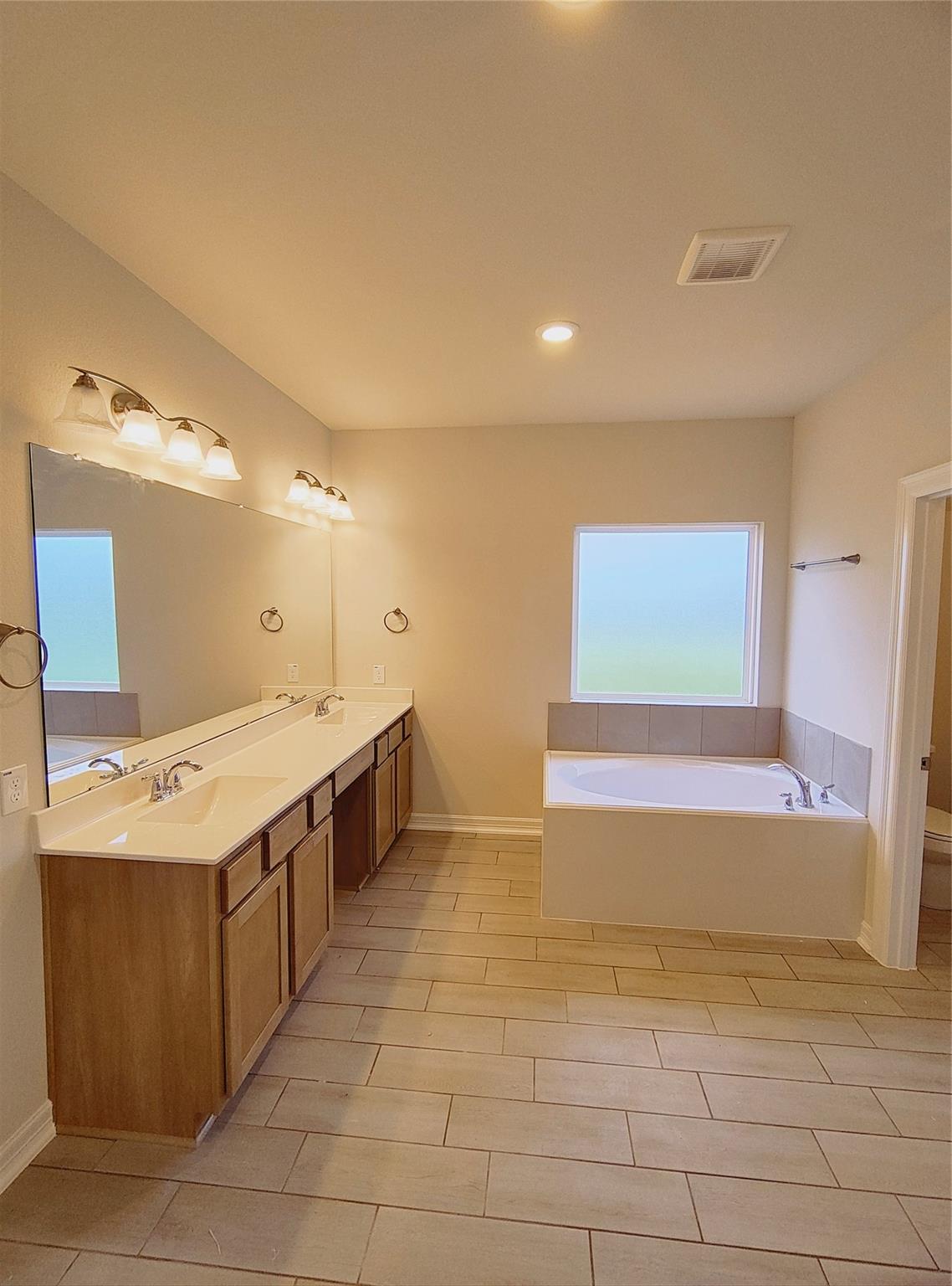 Glorious Luxury Bath Seperate Shower with Bench and Soaker tub. With natural lighting.
