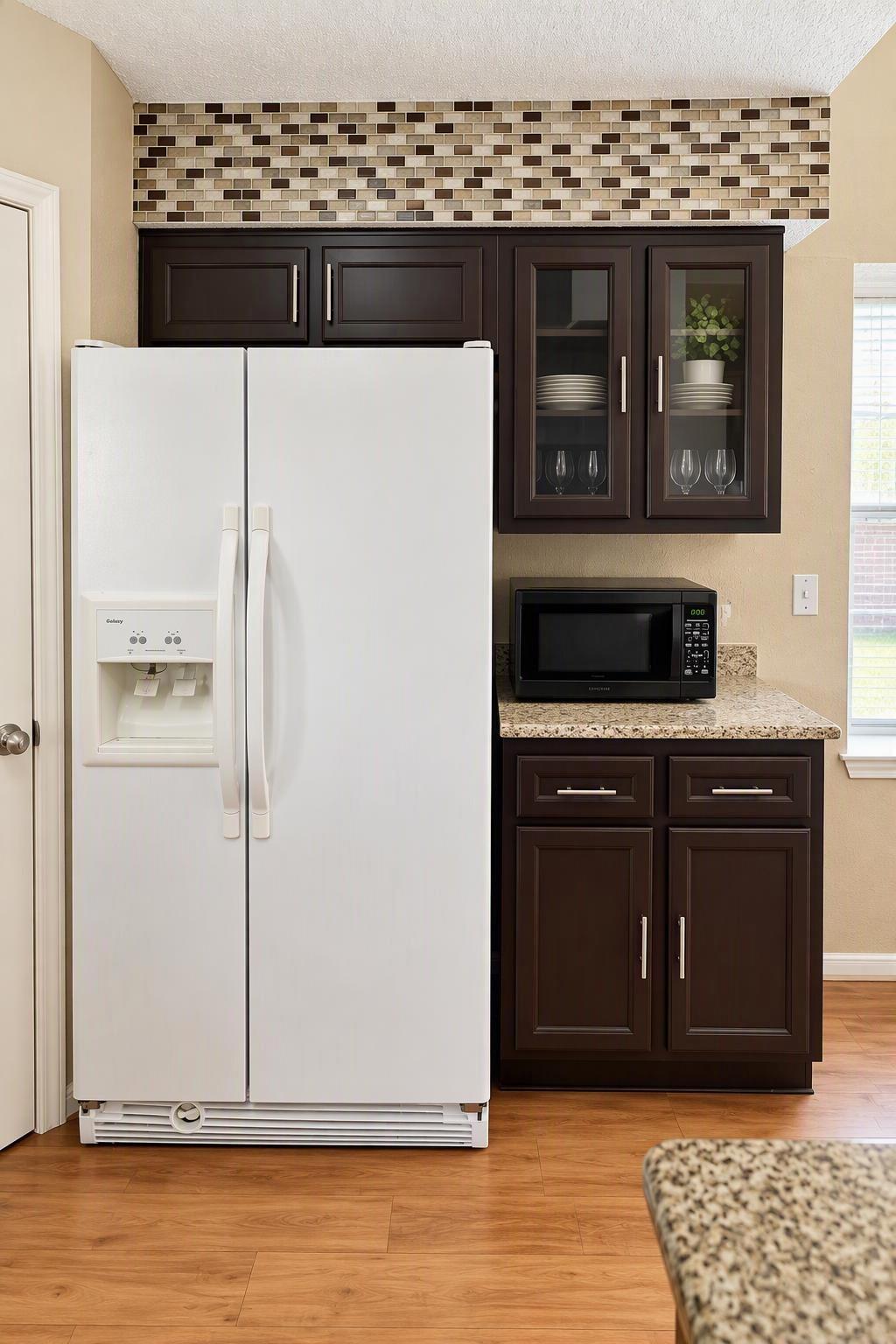 The "pass through kitchen, is an ene=tertainers dream. Ample serving space, Granite counter-tops refrigerator and microwave included