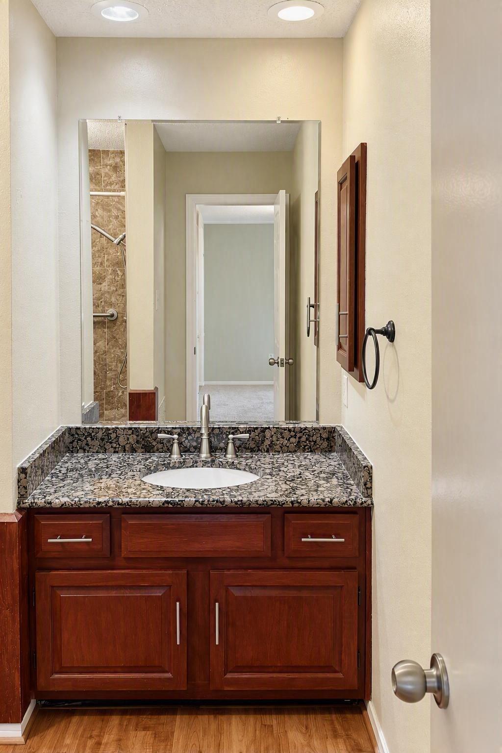 Granite counter-top and large under sink storage, with a wall cabinet for medicines and frequently used products, for ease of access.