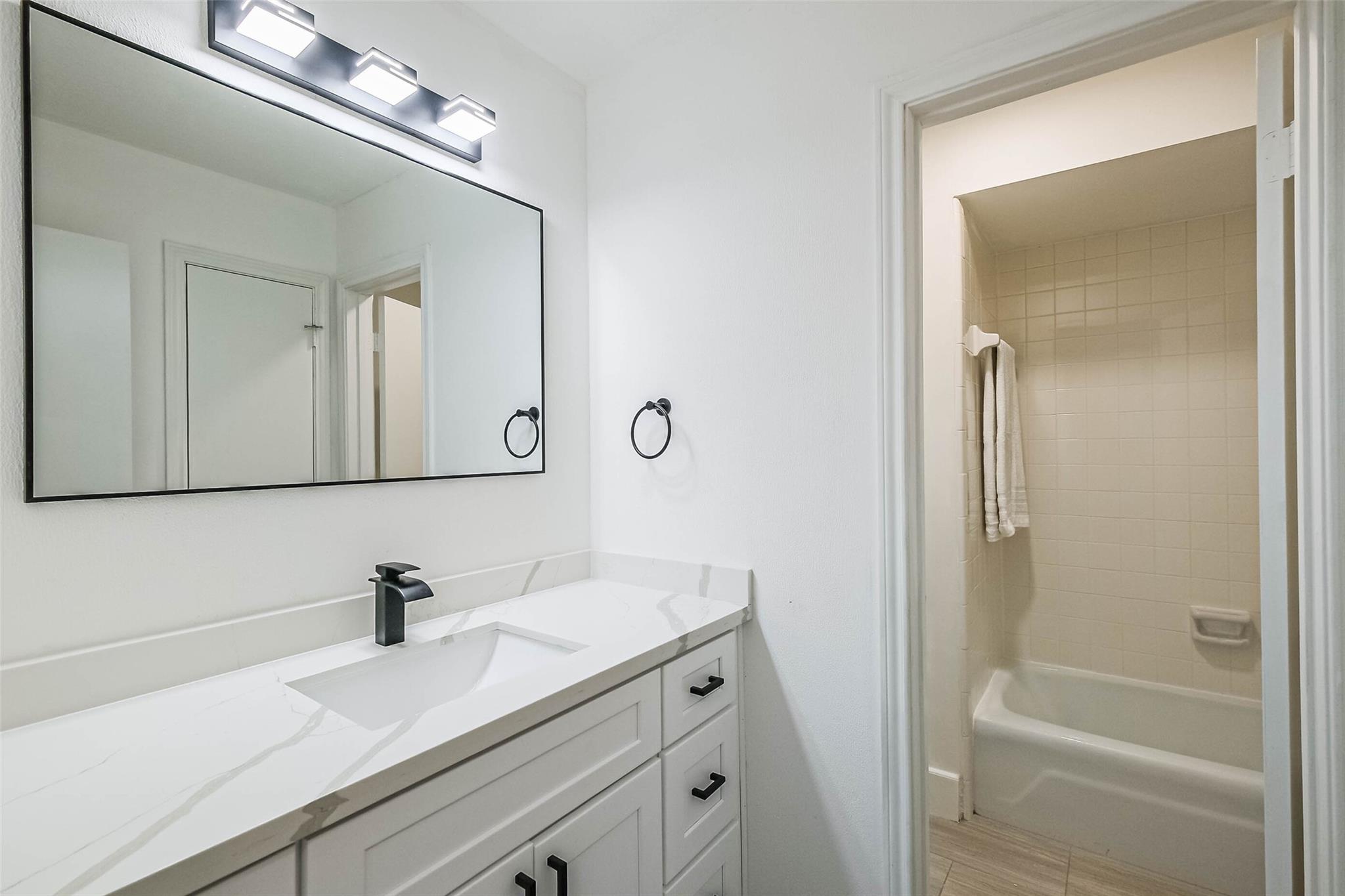 The full bathroom for the 3 other bedrooms on the 2nd floor. Bath / shower combo.